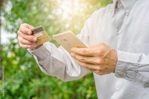 Online payment,Man's hands holding a credit card and using smart phone for online shopping