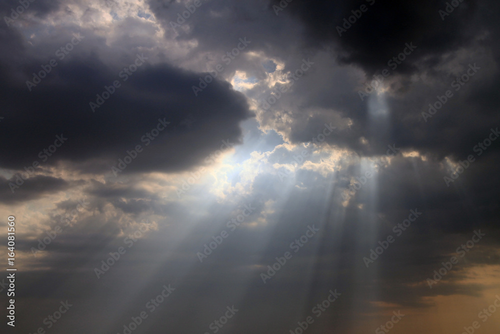Beautiful sky with blue sun rays and dynamic clouds