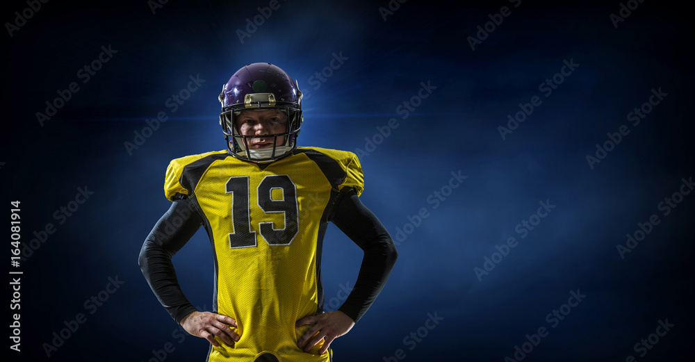 Football player on dark background. Mixed media Football player on dark background. Mixed media