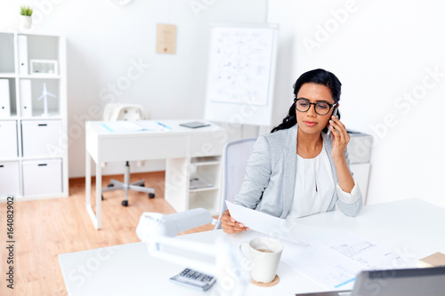 businesswoman calling on smartphone at office