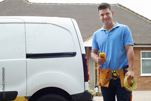 Portrait Of Electrician With Van Outside House