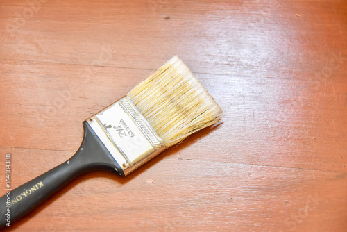 Close-Up View of Paint Brush on Wooden Floor