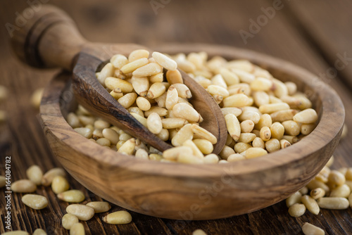 Wooden table with Pine Nuts (selective focus)