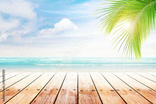 Fototapeta Naklejka Na Ścianę i Meble -  old wood table top on blurred beach background with coconut leaf. Concept Summer, Beach, Sea, Relax.