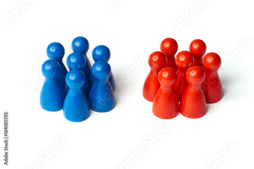 Game figures as a symbol for two groups of people. Concept for teamwork or challange. Isolated on white background.