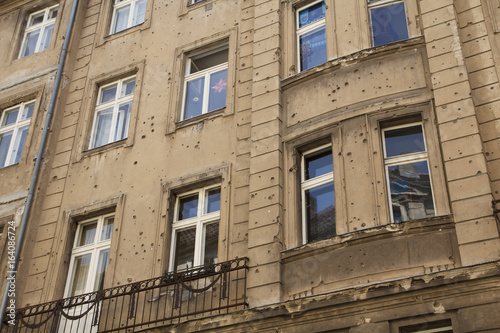 Building with bullet holes of war