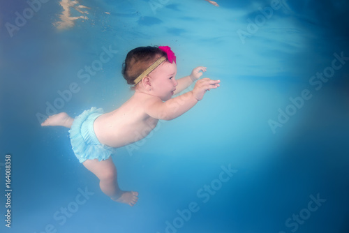 Little girl swims under water