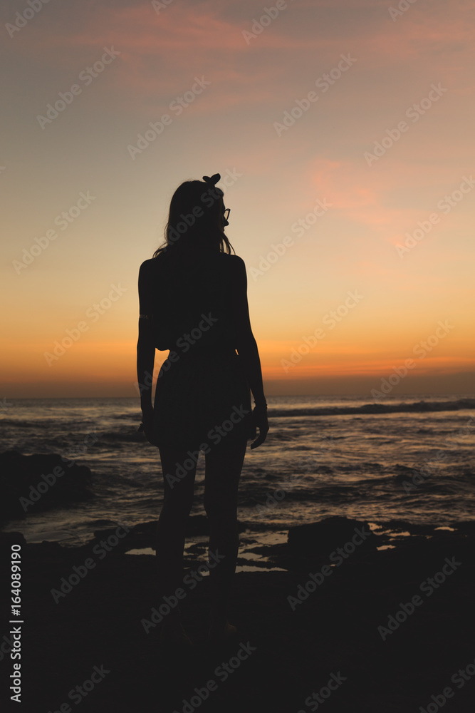 Silhouette of a girl with ocean / sea background.