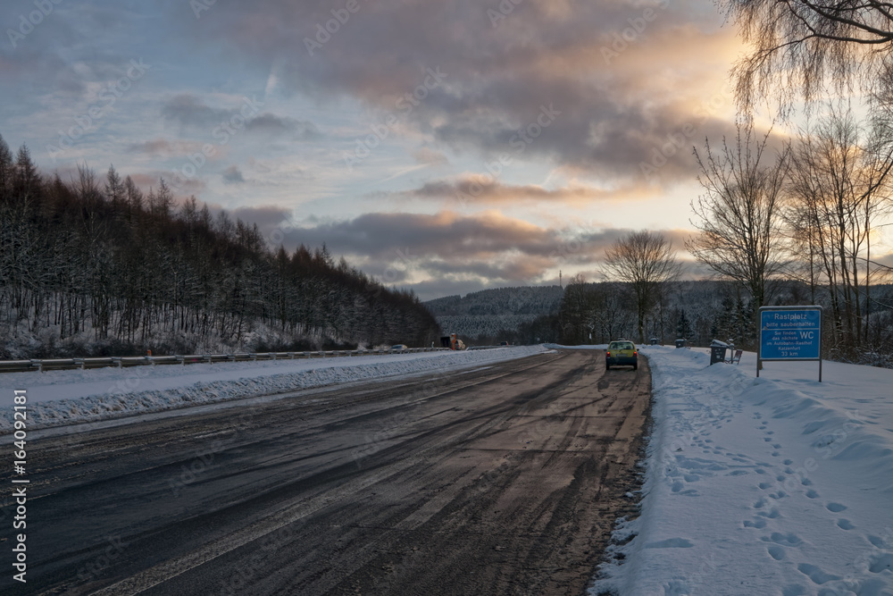 Road by the winter highway, in the evening Road by the winter highway, in the evening