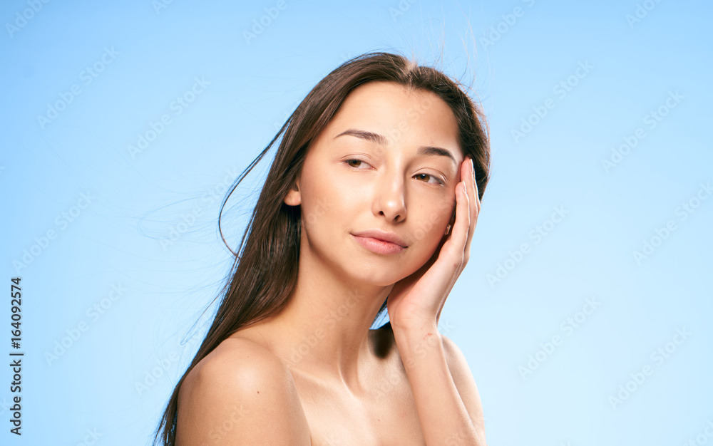 Beautiful young woman on a blue background, portrait Beautiful young woman on a blue background, portrait