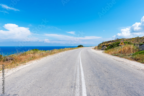 Beautiful coastal road along crystal blue sea water on Milos island. Cyclades  Greece