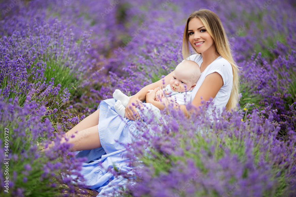 Happy mother and her little baby boy having fun in a lavender field Happy mother and her little baby boy having fun in a lavender field