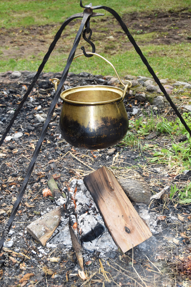 Metal medieval pot for cooking on fire Metal medieval pot for cooking on fire
