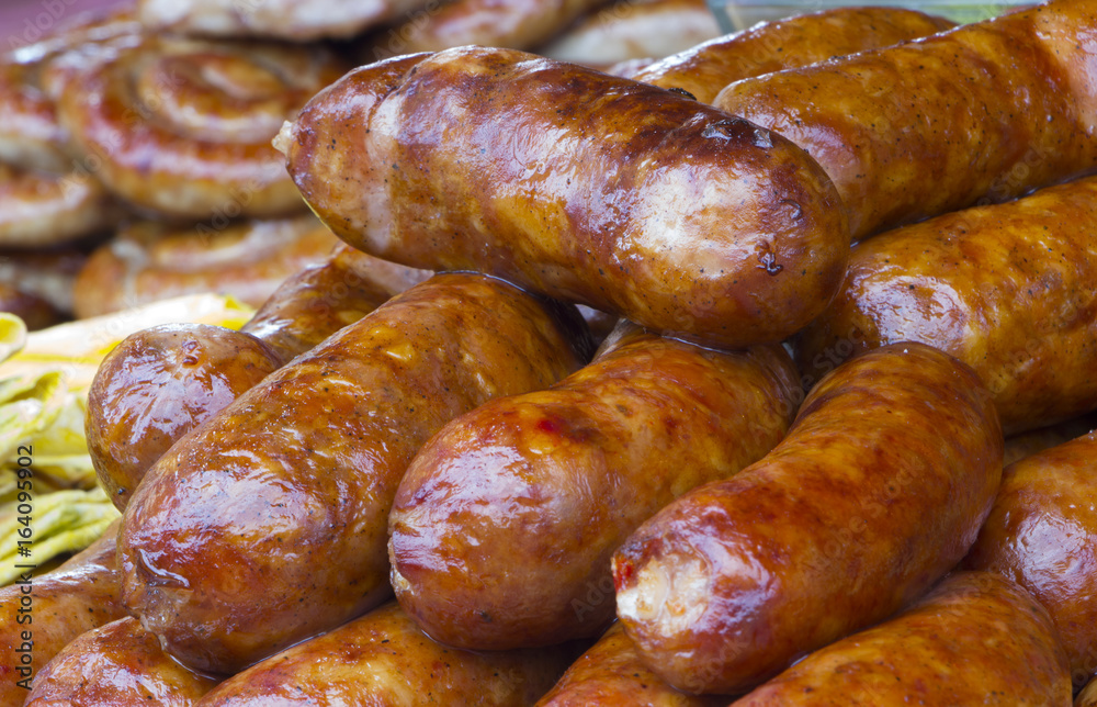 Fototapeta premium Traditional food. Smoked sausages meat hanging in domestic smokehouse