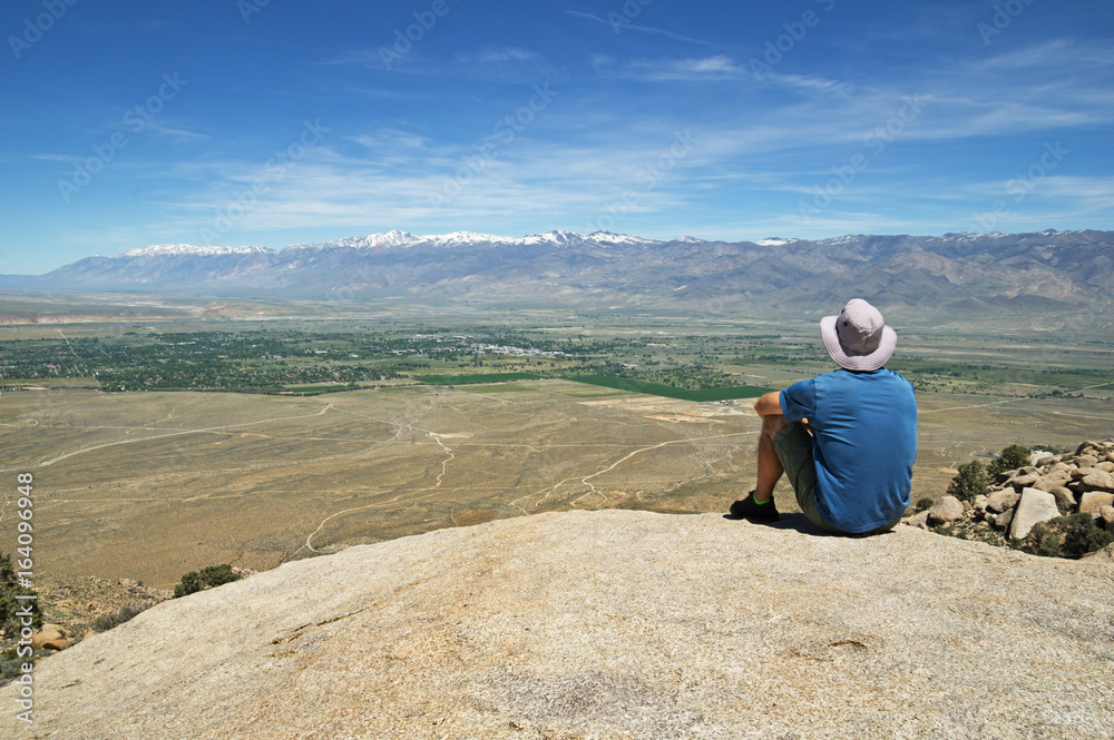 Man Sits On Rock Overlook