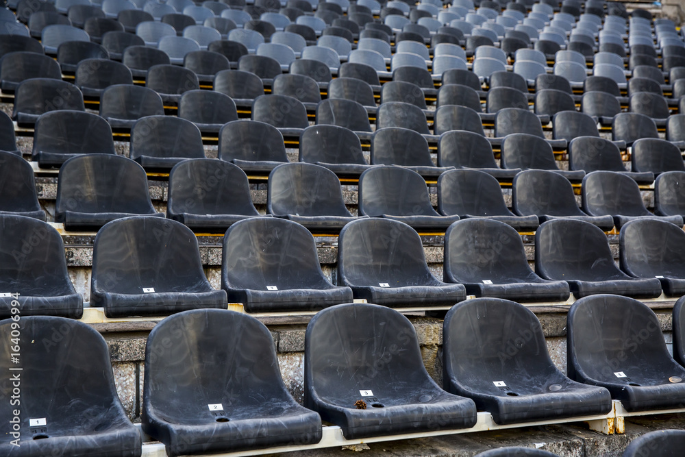 Fototapeta premium Empty tribune with black seat on soccer sdadion