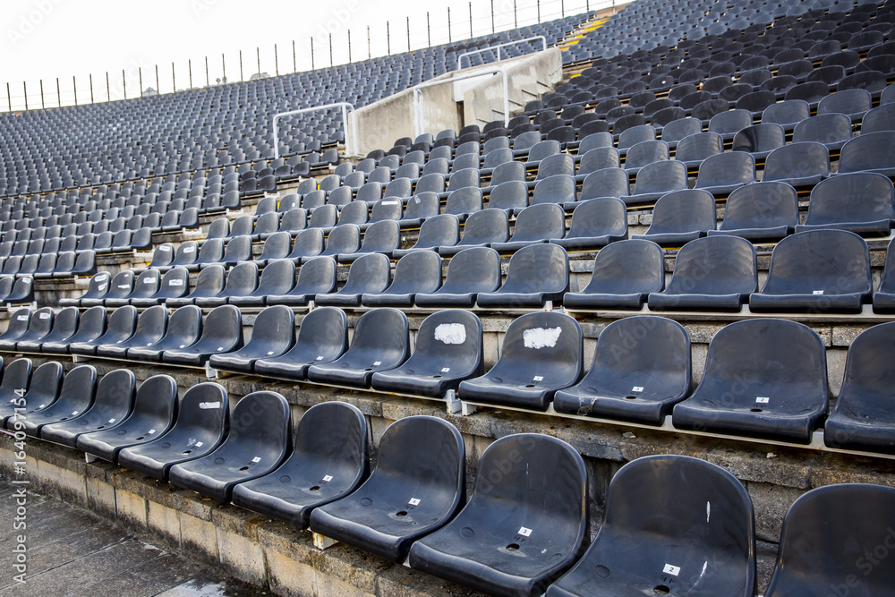 Fototapeta premium Empty tribune with black seat on soccer sdadion