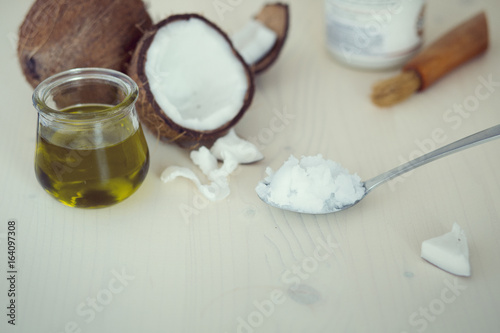 spoon filled with raw coconut oil used on beauty and kitchen