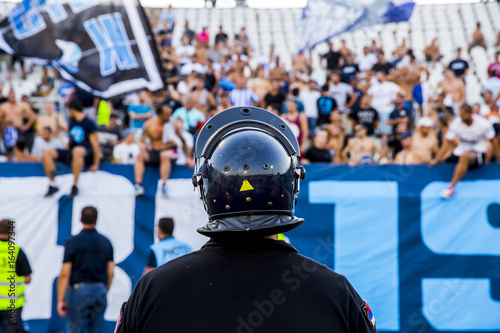policeman with helmet guarding a sport event