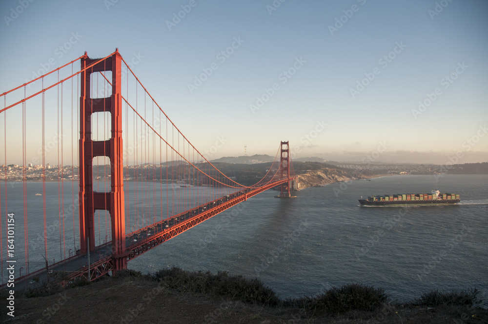 Golden Gate Bridge evening with container ship