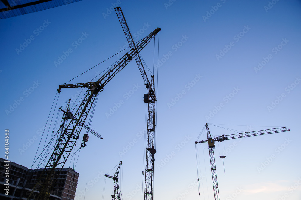 tower cranes silhouette at construction site tower cranes silhouette at construction site