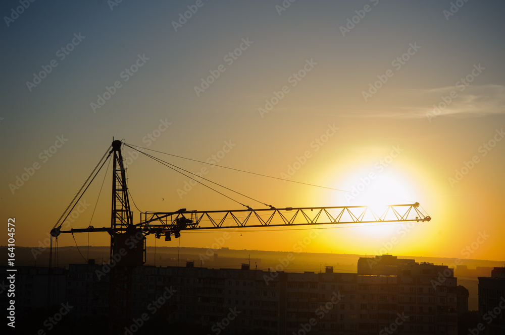 tower cranes silhouette at construction site