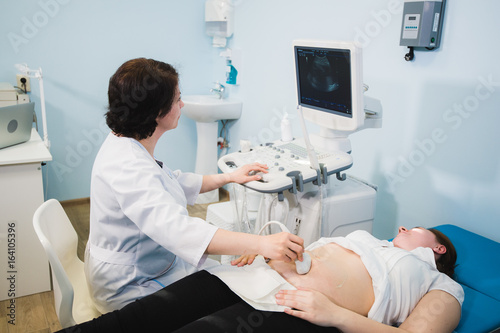 Pregnant woman receiving ultrasound treatment in hospital