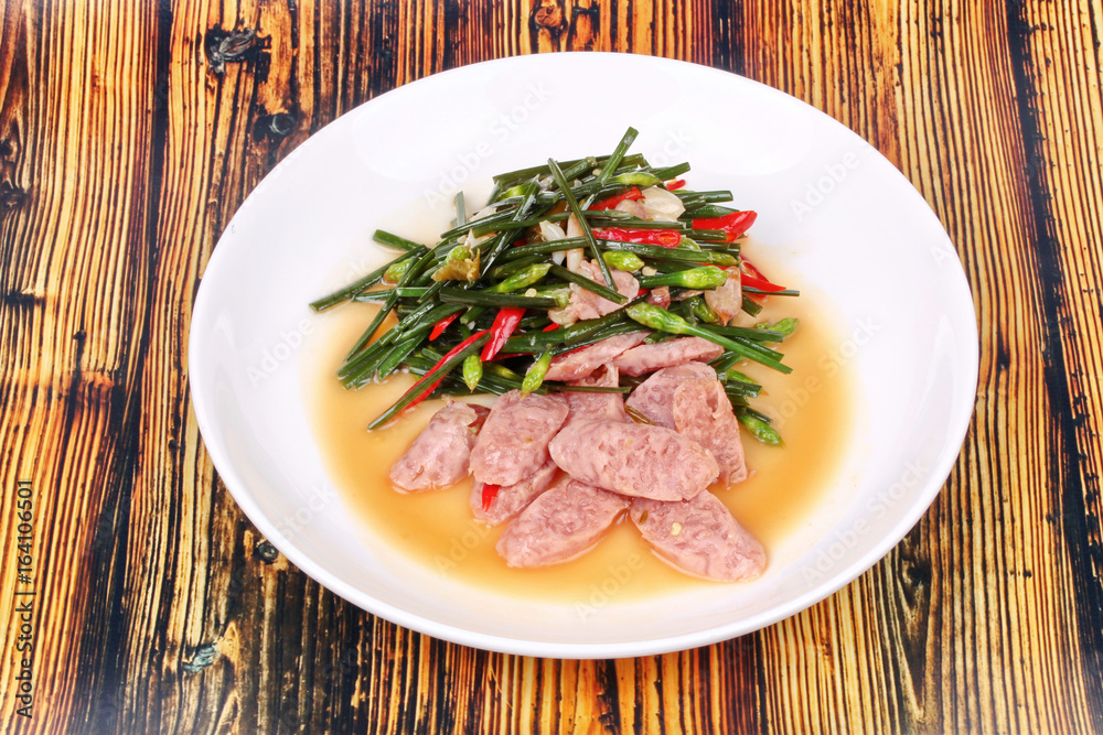 Fried Chinese chives with Thai sour sausage . Fried Chinese chives with Thai sour sausage .