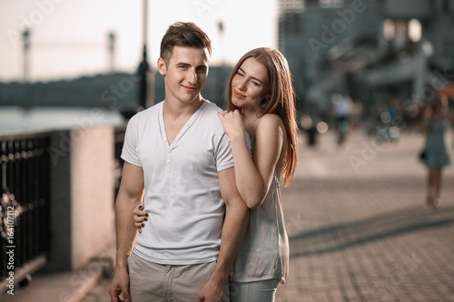 Portrait of young couple in love, enjoying the sunset in city