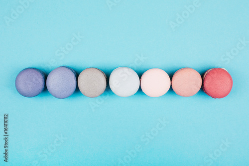 Group of pastel colorful macarons on trendy background photo