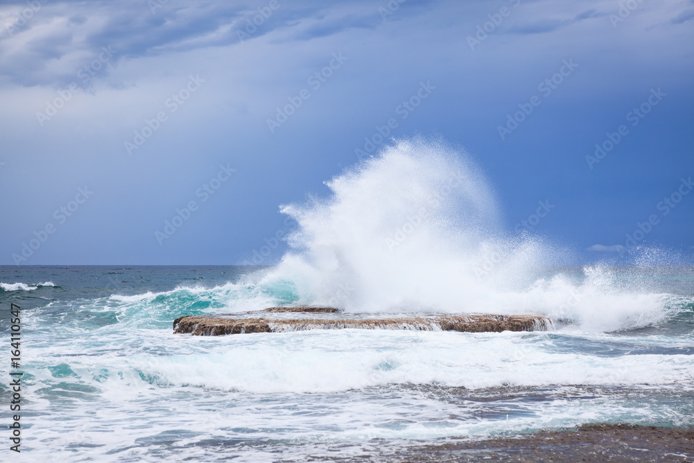 Waves crashing on rock