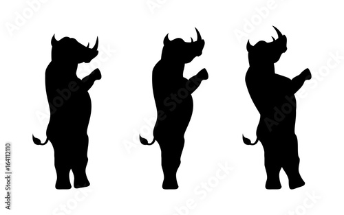 Rhinoceros silhouette stands on two legs isolated on white background photo