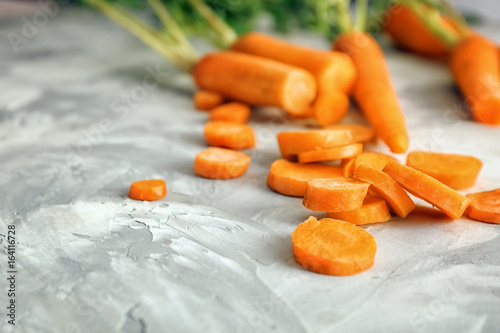 Slices of carrot on grey background