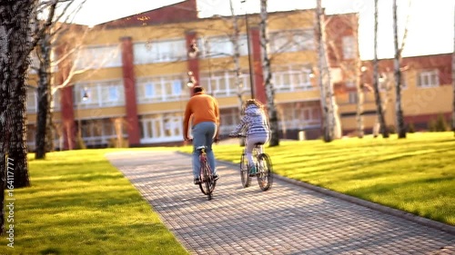 Wallpaper Mural Young athletic couple rides his bike in a holiday park Torontodigital.ca
