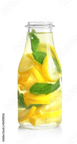 Bottle of fresh lemonade on white background