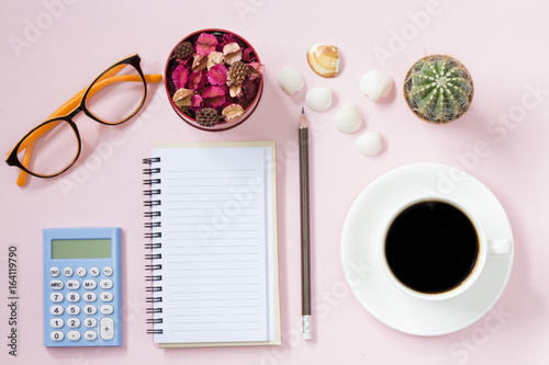 Copyspace of topview empyt page and calculator coffee and dried flower with cactus and shell. photo