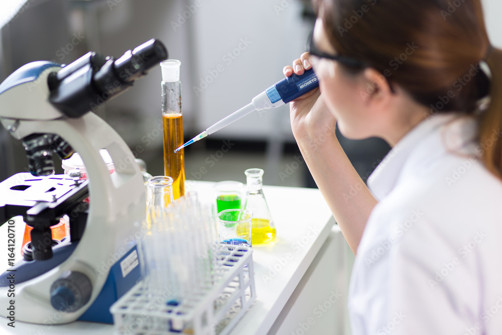 Young medical technicians working in laboratory Young medical technicians working in laboratory