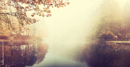 Vintage Autumn Landscape with Fog over Lake