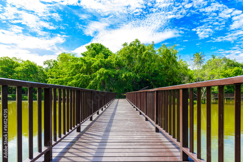 Wooden bridge walkway in Sri Nakhon Khuean Khan Park and Botanical Garden © sirastock
