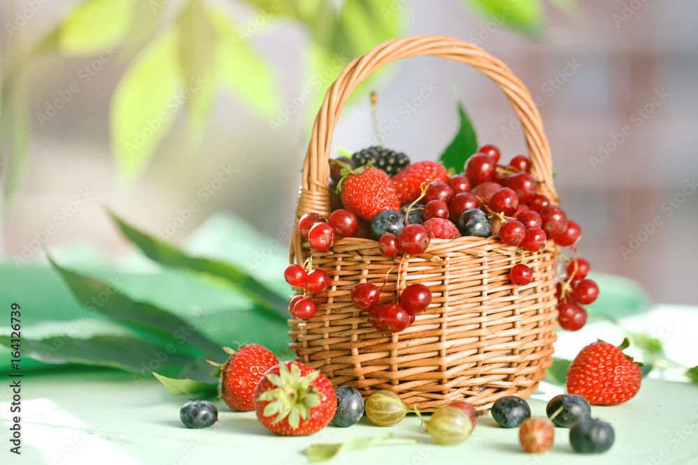 Ripe berries in a basket on a wooden table. Ripe berries in a basket on a wooden table.