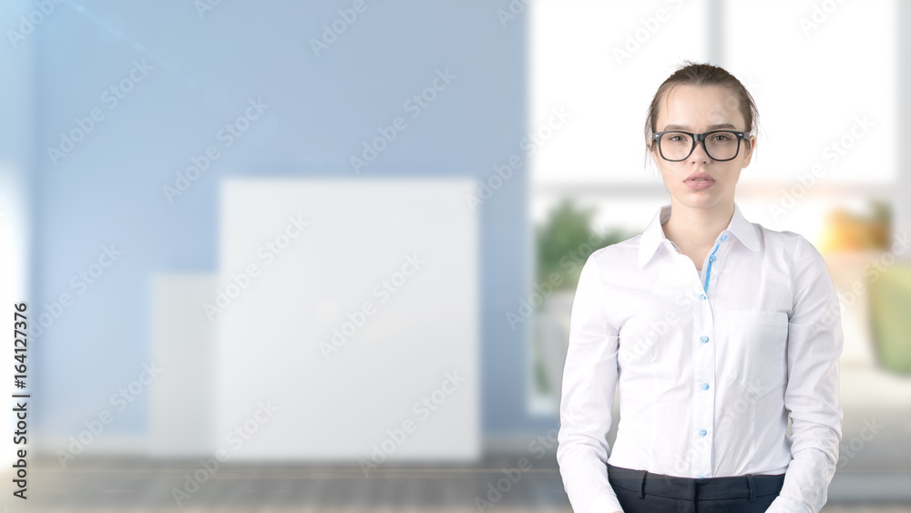 Young beautiful business woman and creative designer standing over blured interior background
