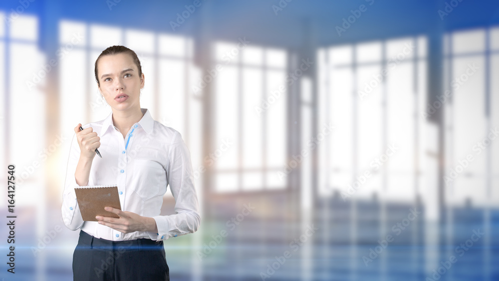 Young beautiful business woman and creative designer standing over blured interior background Young beautiful business woman and creative designer standing over blured interior background
