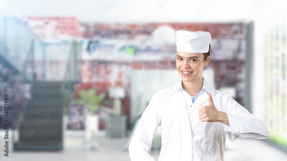 Beautiful medical woman doctor in uniform. Studio painted background. Concept of profitable health care.