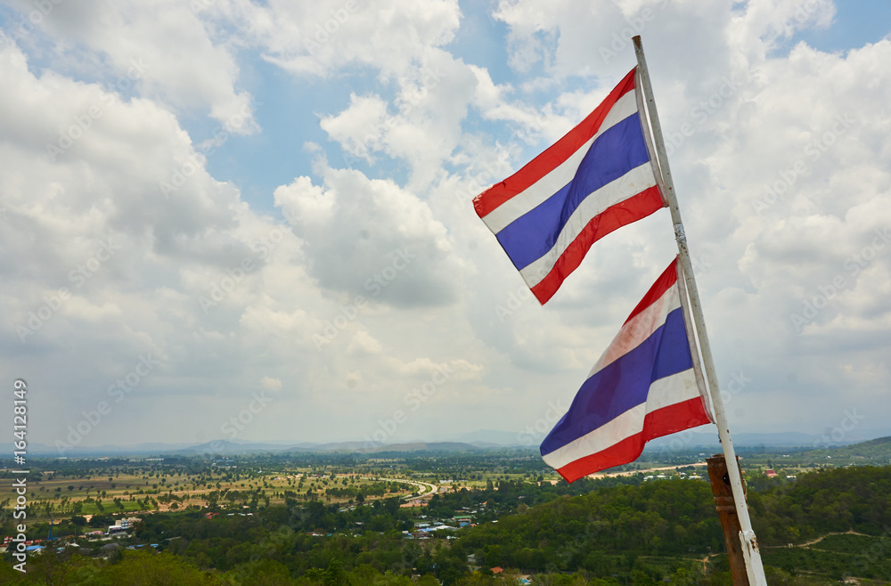 Thailand flag over the small village in cloudy day