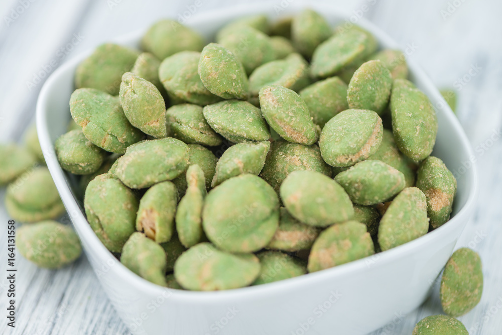 Portion of Wasabi coated Peanuts on wooden background (selective focus) Portion of Wasabi coated Peanuts on wooden background (selective focus)