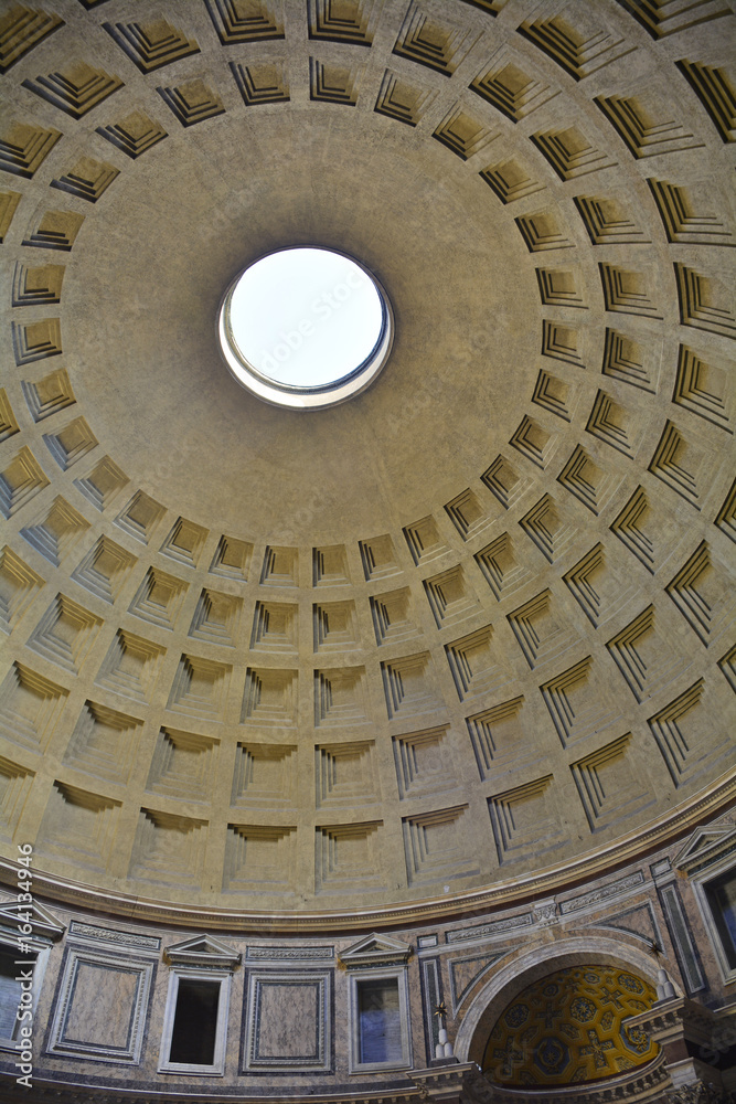 The landmark Pantheon in Rome, Italy. Originally a temple, and now a church, it has a coffered concrete dome which has a central opening or oculus to the sky.
