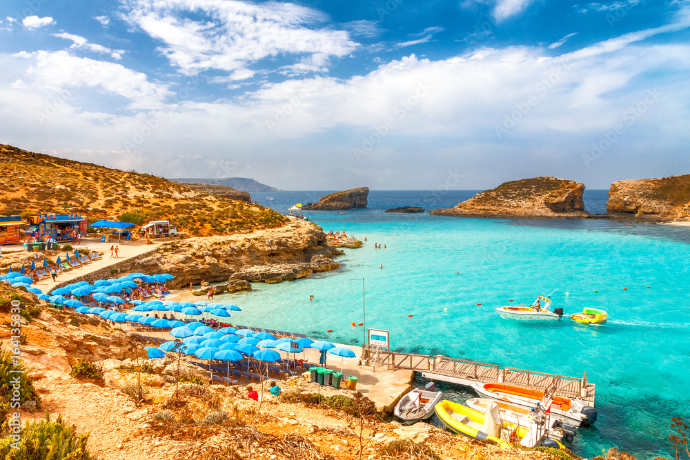 Turquoise lagoon with beach near the Comino island between the islands of Malta and Gozo in the Mediterranean Sea, Europe.