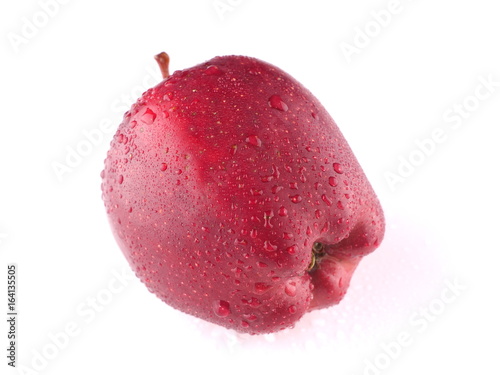 Red apple on a white background with droplets