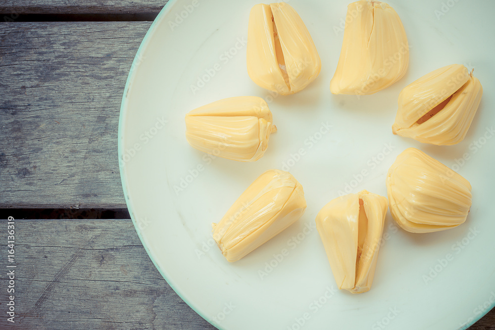 Fresh jackfruit in the bowl on wood table. Fresh jackfruit in the bowl on wood table.