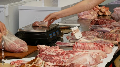Woman buy meat at the market